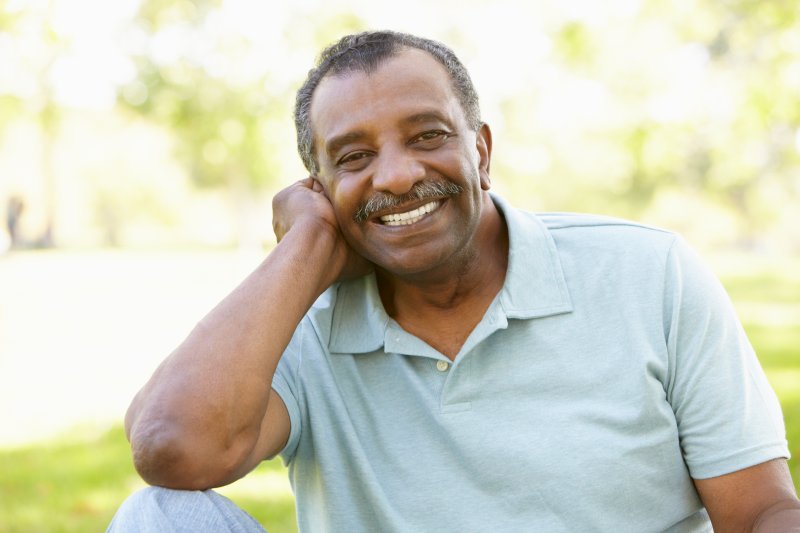 Older patient smiling with dental implants